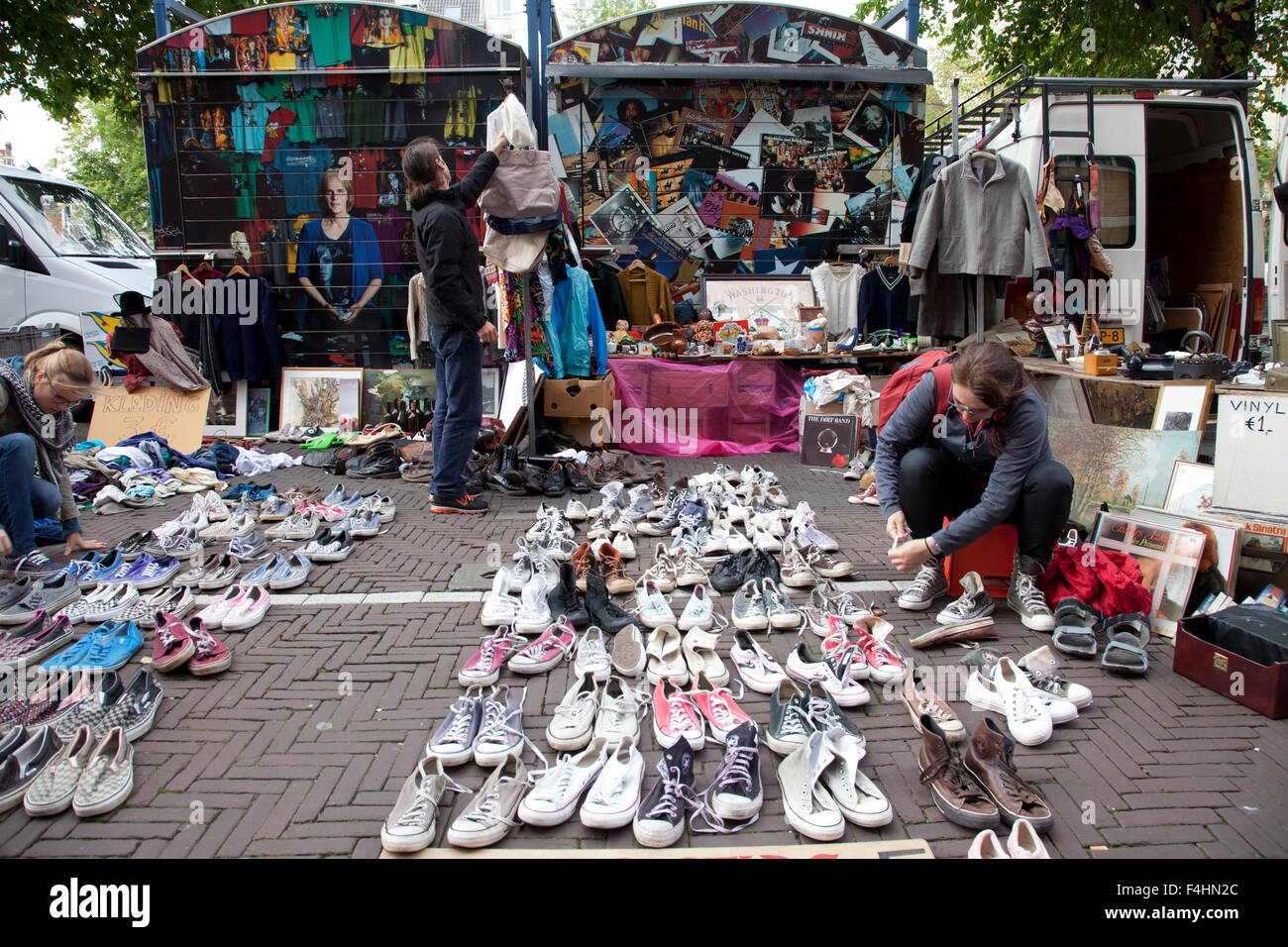 Shoes and clothes compete with tee shirts and vinyl records in this stall at the Waterlooplein Flea Market in Amsterdam. Stock Photo