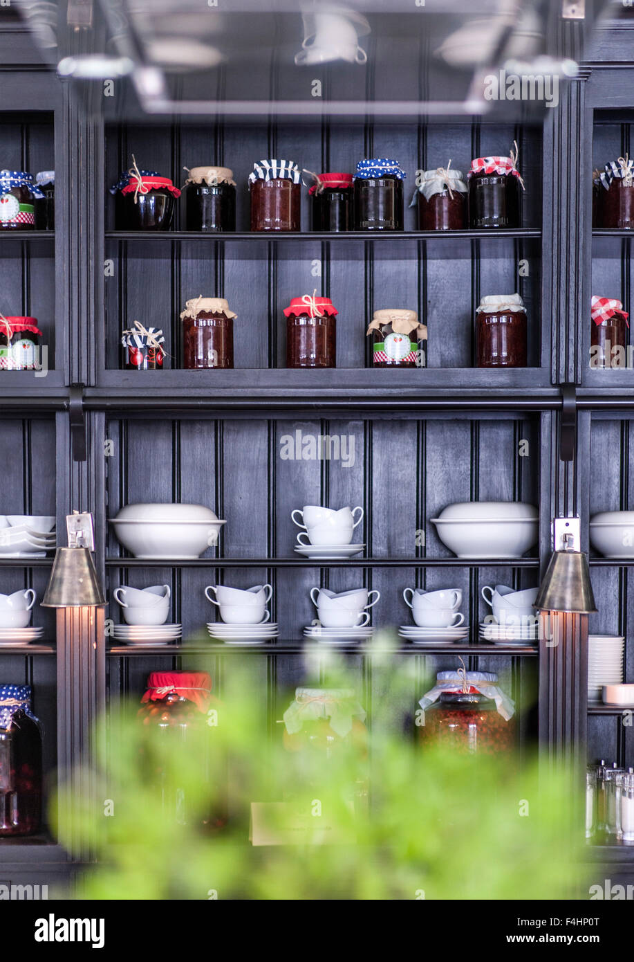 Confectionery jars and crockery on shelves at the Rooms Hotel in Kazbegi, northern Georgia. Stock Photo