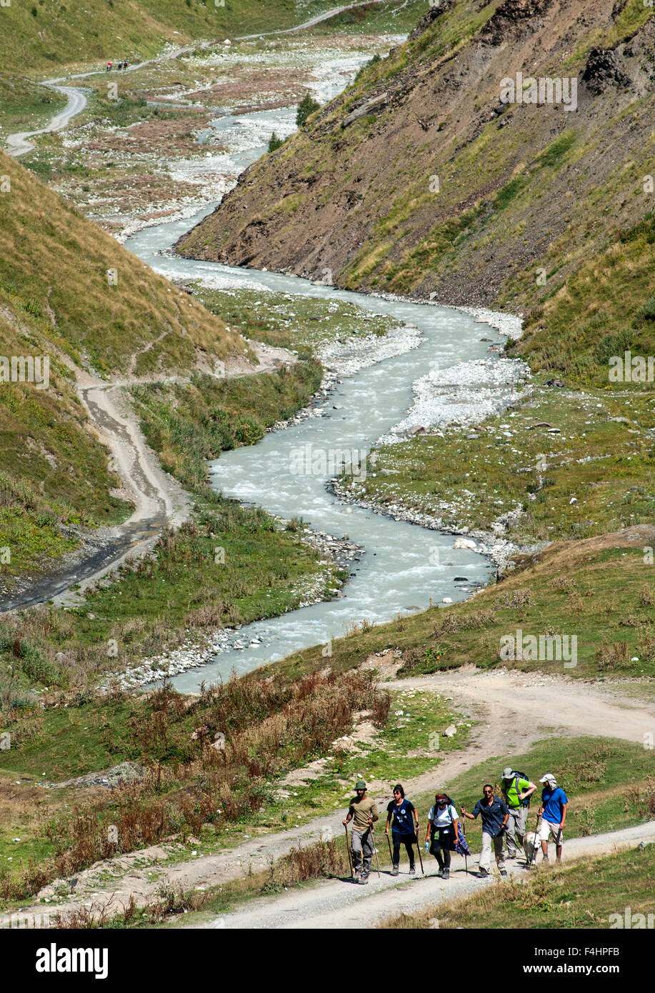 Hikers in the foothills of Mount Shkhara (the highest mountain in Georgia), Svaneti region, Caucasus mountains, Georgia. Stock Photo