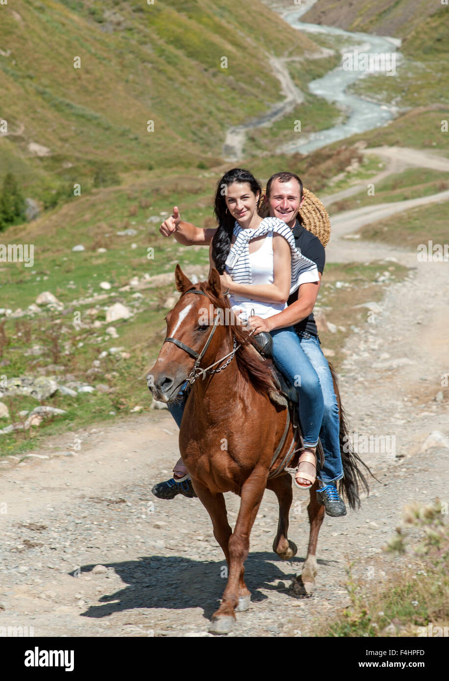 Horse riding in the foothills of Mount Shkhara (the highest mountain in Georgia), Svaneti region, Caucasus mountains, Georgia. Stock Photo