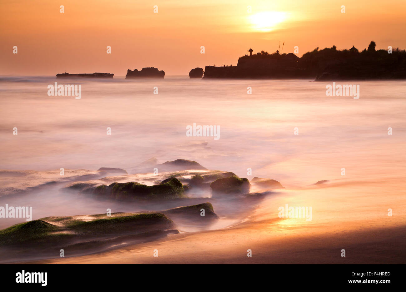 Sunset silhouettes on the coast of Bali, Indonesia Stock Photo