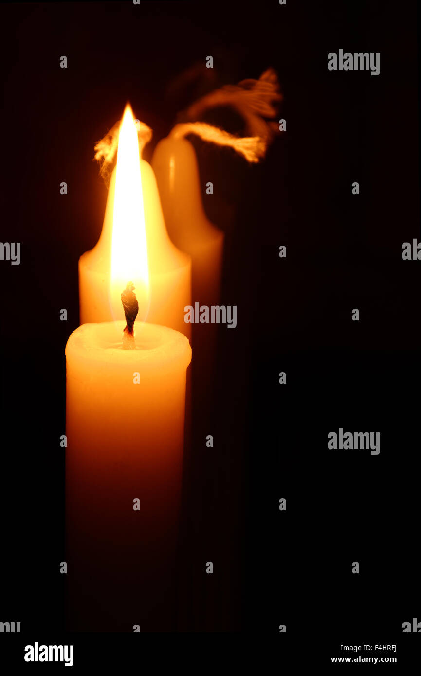 closeup of a burning candle against the black background Stock Photo Alamy