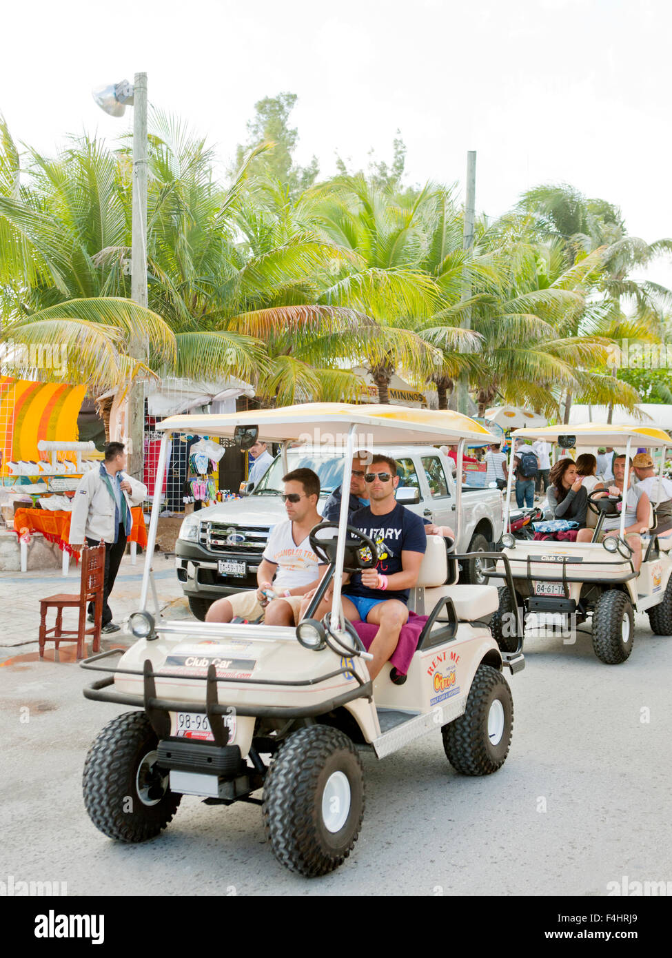 Tourists on golf carts, Isla Mujeres. Golf carts are the main source of