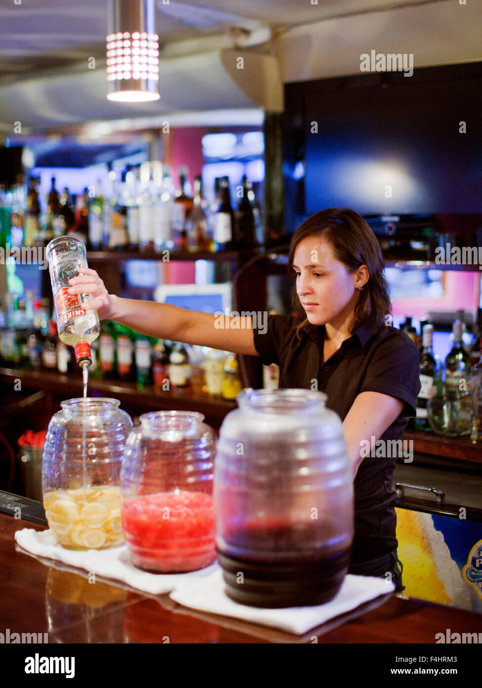A bartender at John Gray's Place steeps lemons, watermelon and hibiscus with vodka. Calle Corazon, Playa del Carmen, Mexico. Stock Photo