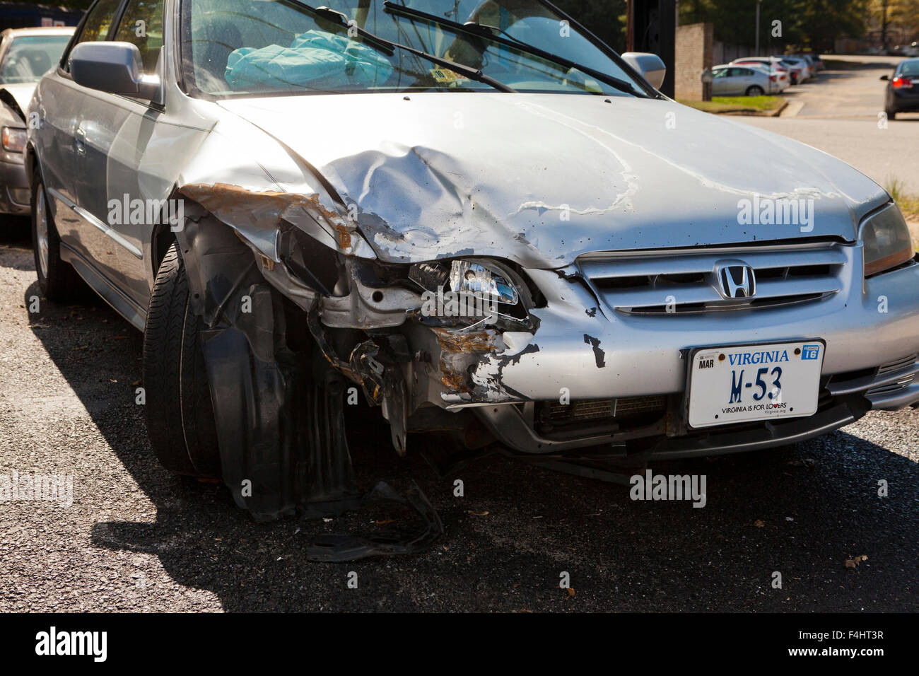 Front end accident damage on car at auto body repair shop - USA Stock Photo