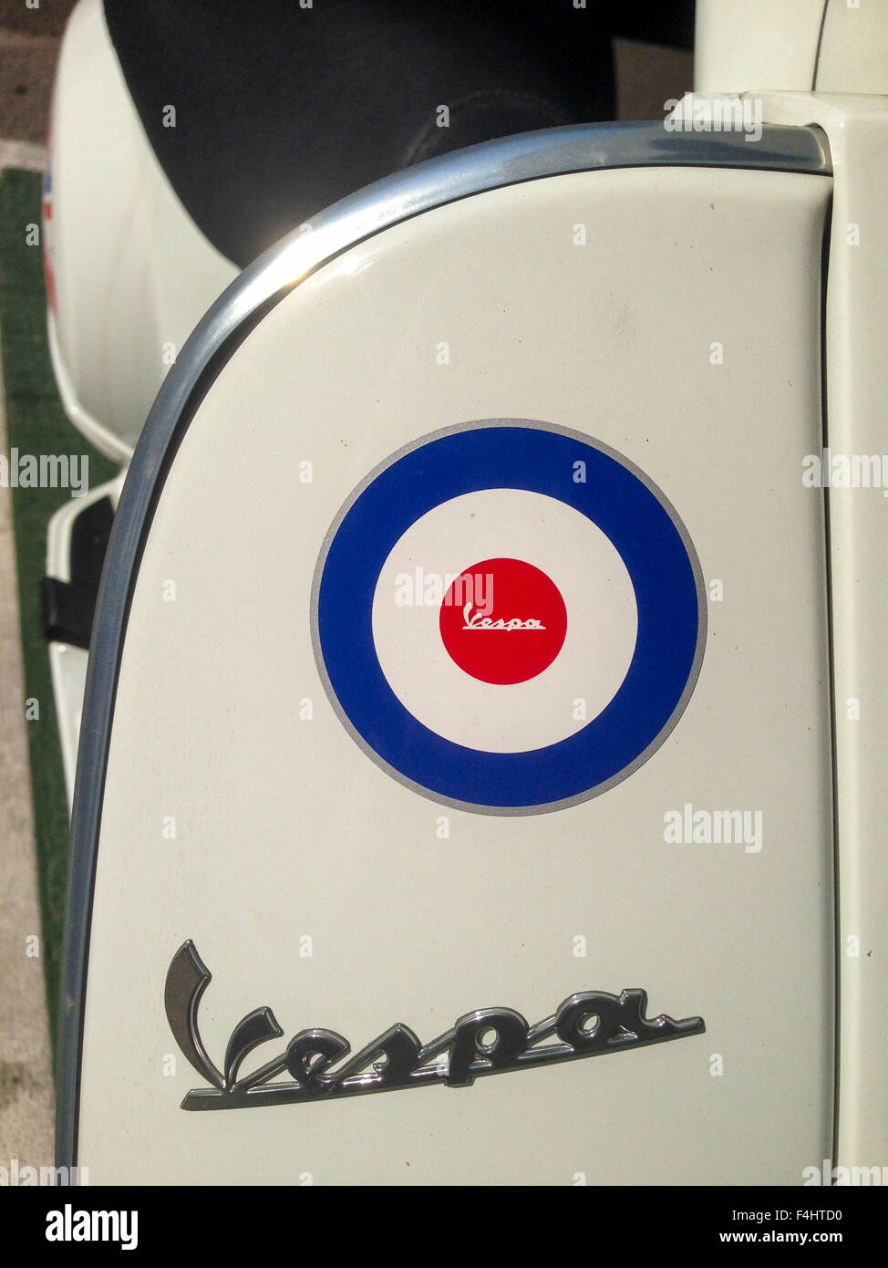 BADAJOZ, SPAIN JUNE 29 : Close up detail of elegantly designed Vespa Italian scooter logo with red and blue color cirlces parked Stock Photo