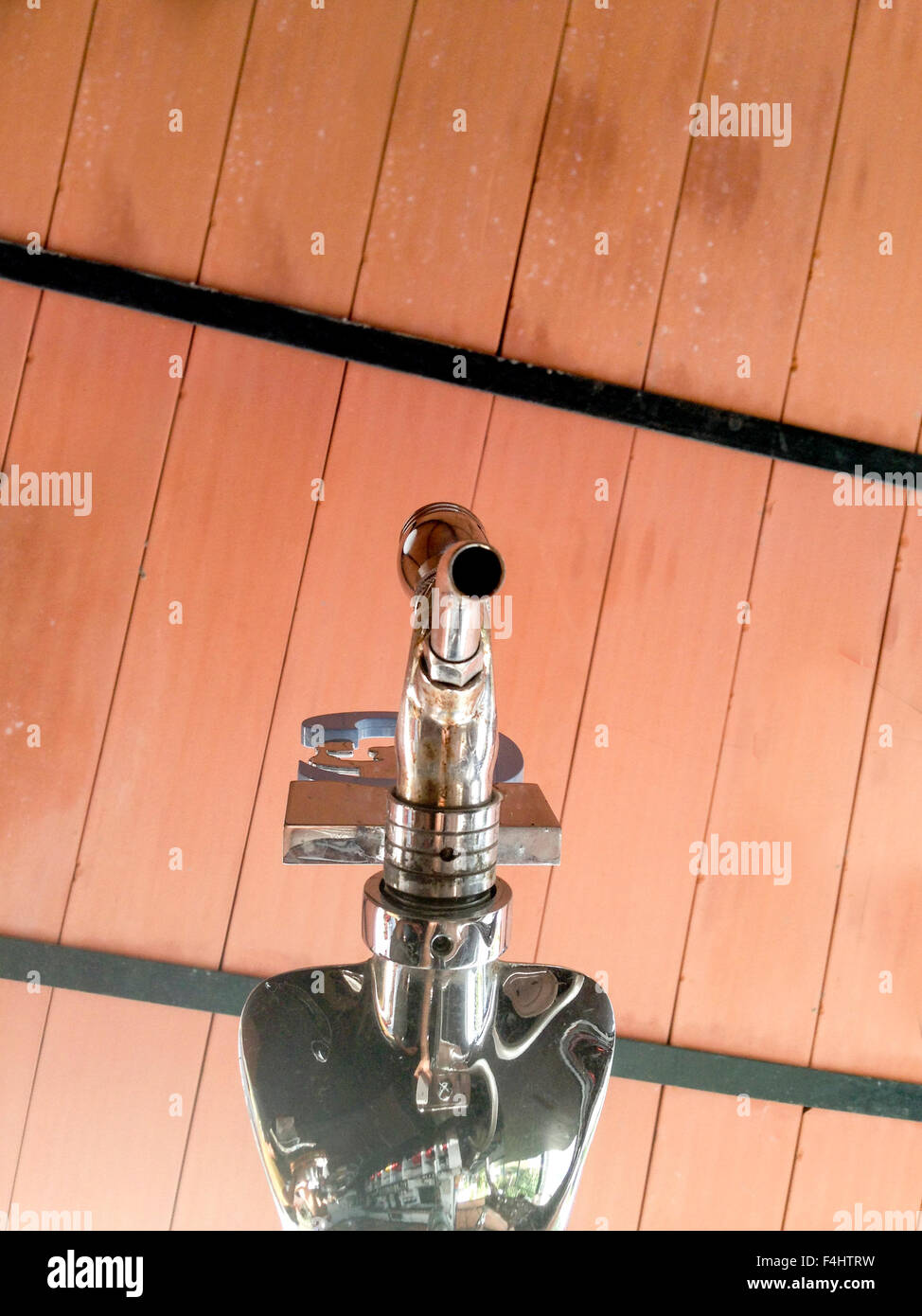 Low angle shot of beer faucet isolated over red ceiling Stock Photo