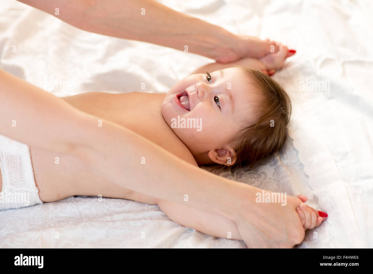 Mom does physical fitness exercises with her baby Stock Photo