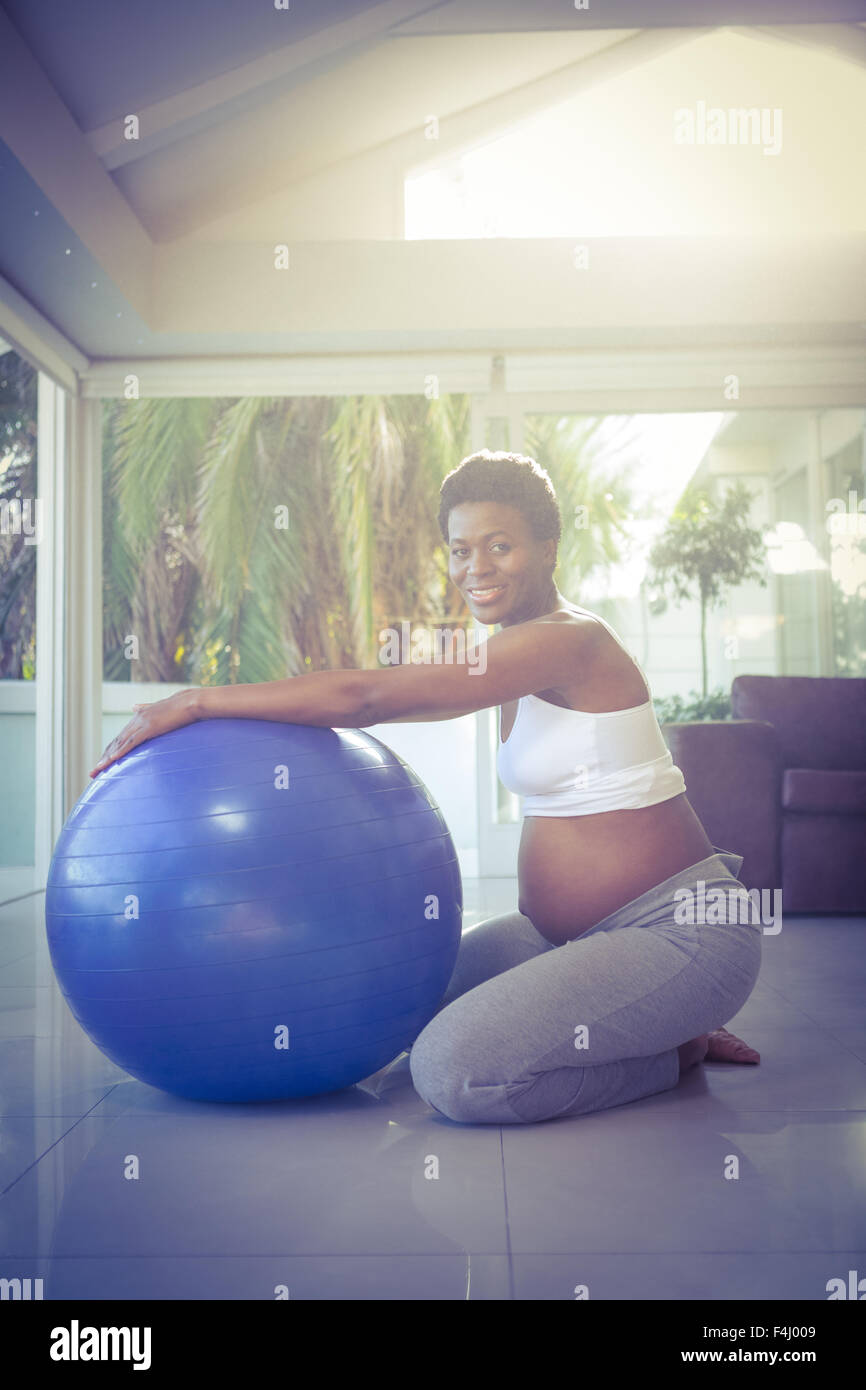 Portrait of cheerful woman exercising with ball Stock Photo