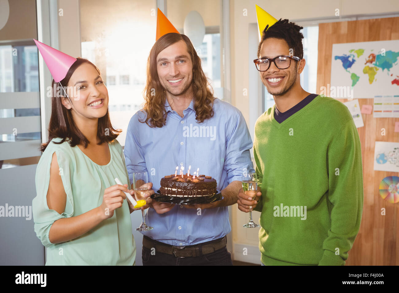 Portrait of happy creative business people with cake and champagne Stock Photo
