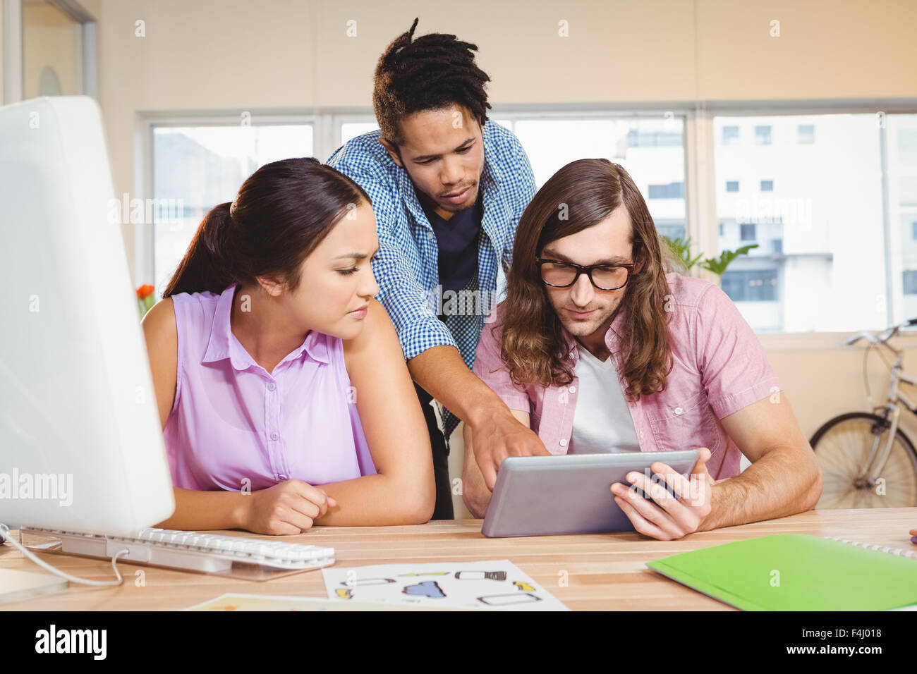 Business people discussing over digital tablet during meeting Stock Photo