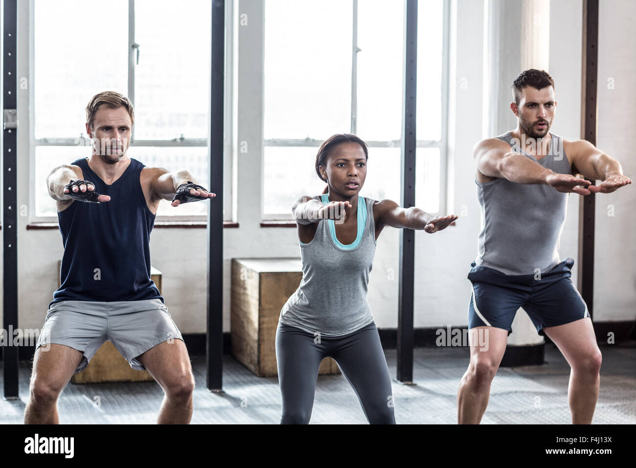 Three fit athletes stretching together Stock Photo Alamy
