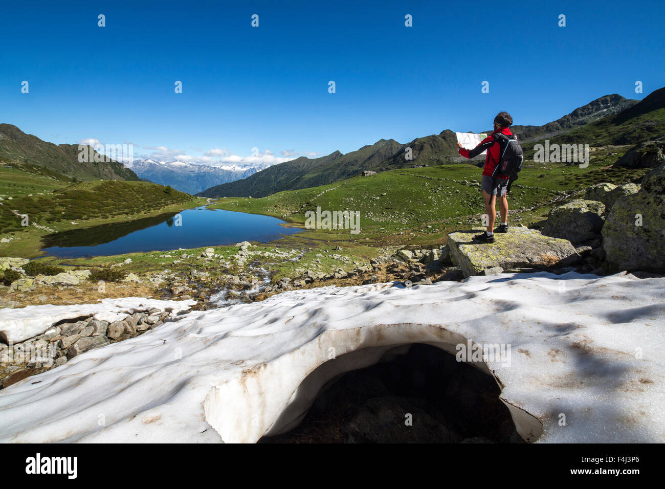 Hiker at Lakes Porcile, Tartano Valley, Orobie Alps, Lombardy, Italy, Europe Stock Photo