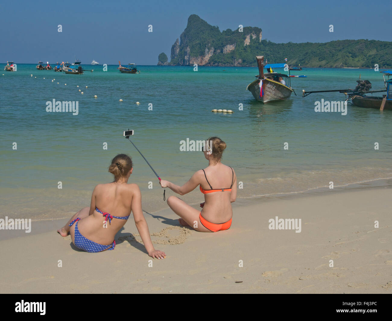 Western women tourists take selfie photo on beach at Phi Phi islands, Andaman sea, Thailand, Southeast Asia, Asia Stock Photo