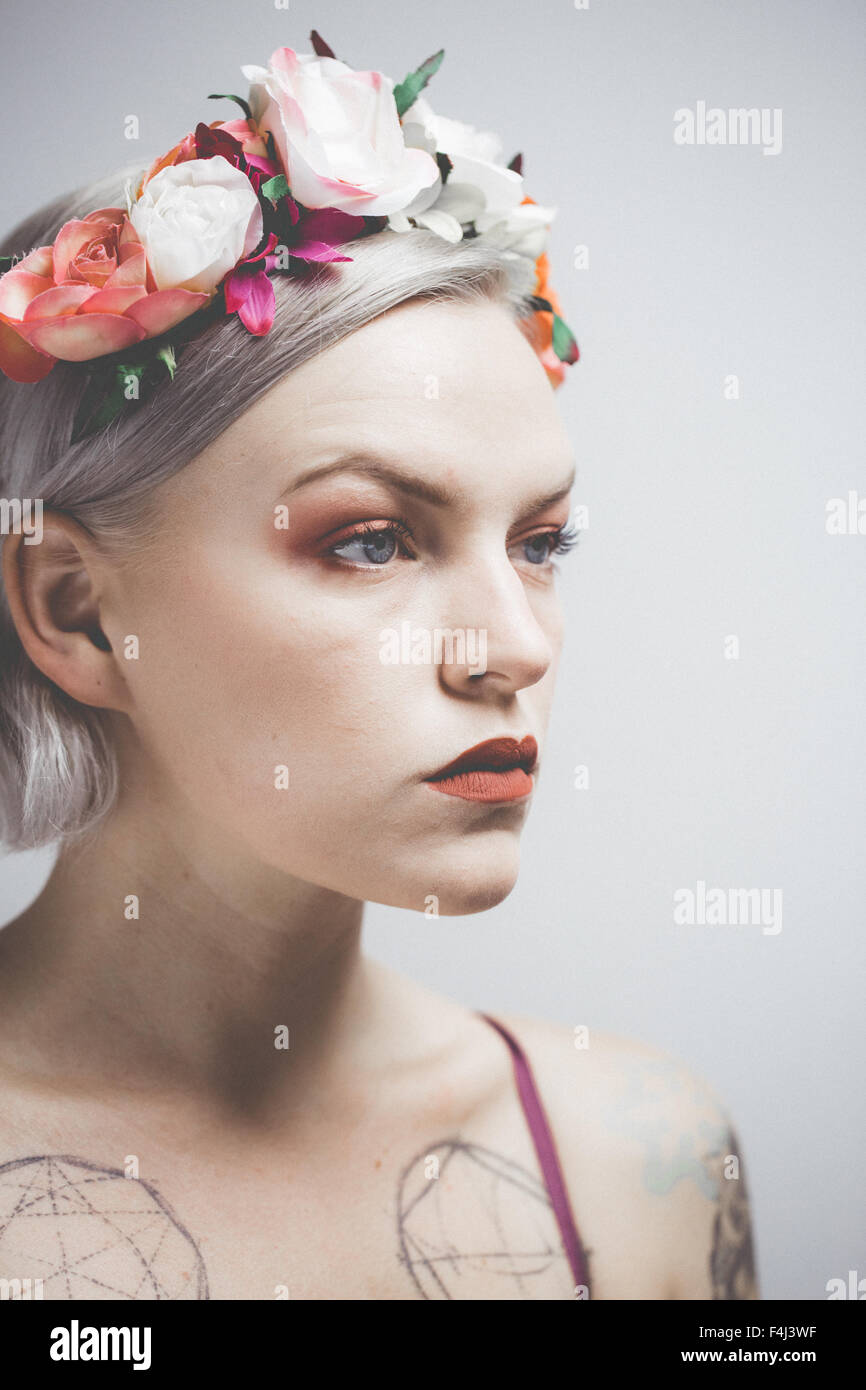 Young tattooed woman wearing a flower crown Stock Photo