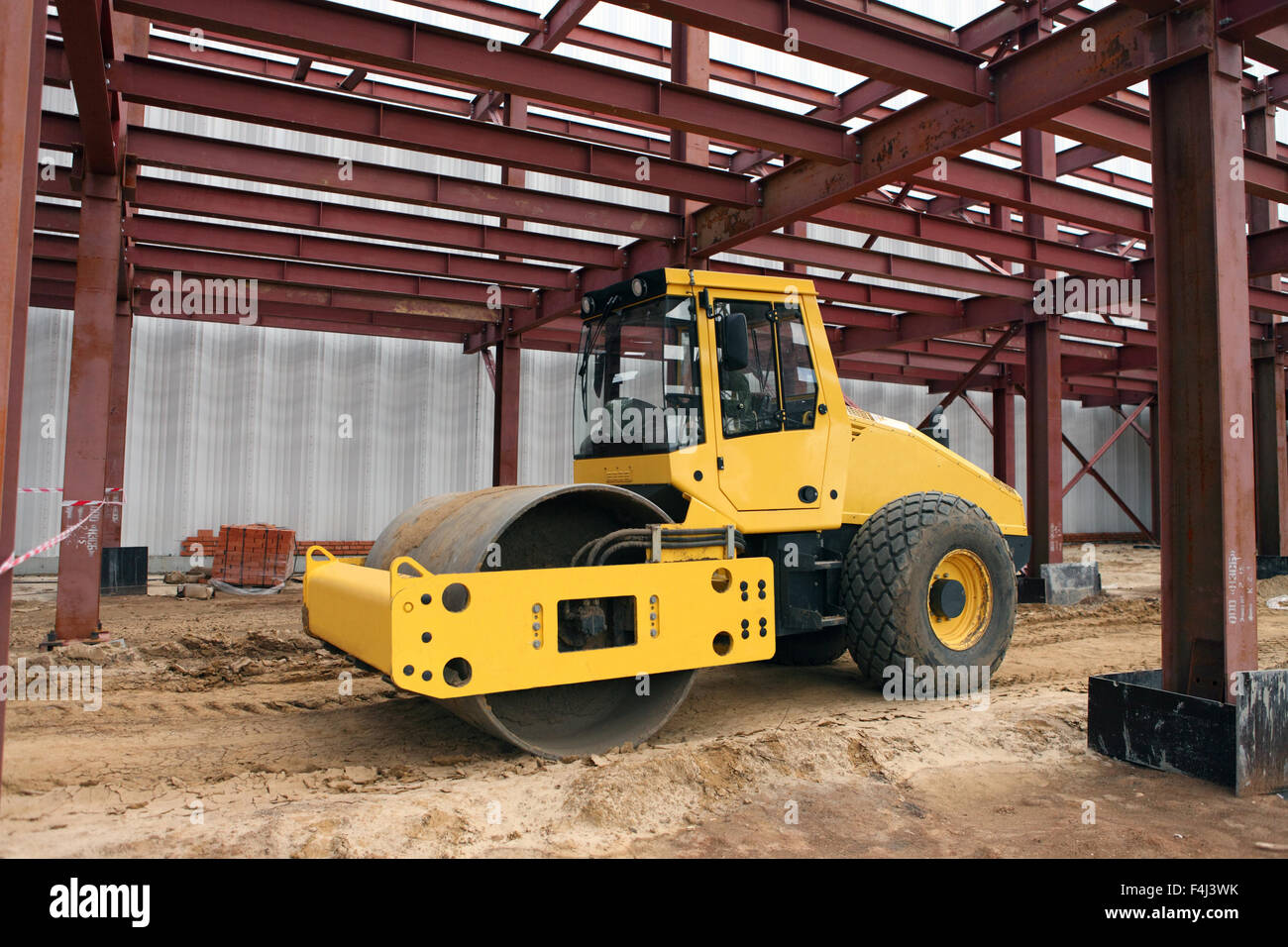 Large road roller being used to construct Stock Photo