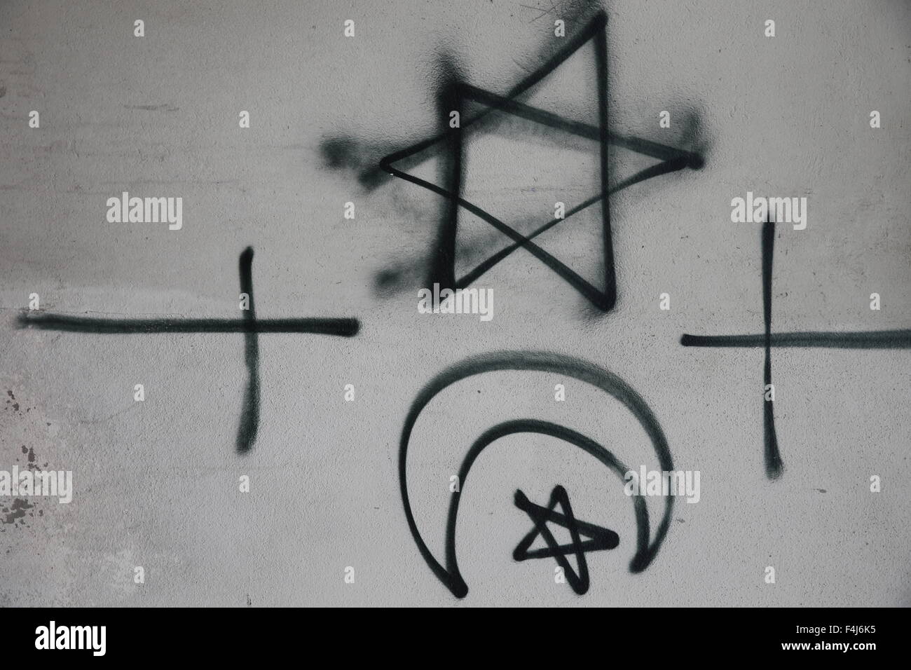 Religious symbols tagged on a wall, Montrouge, Hauts-de-Seine, France, Europe Stock Photo