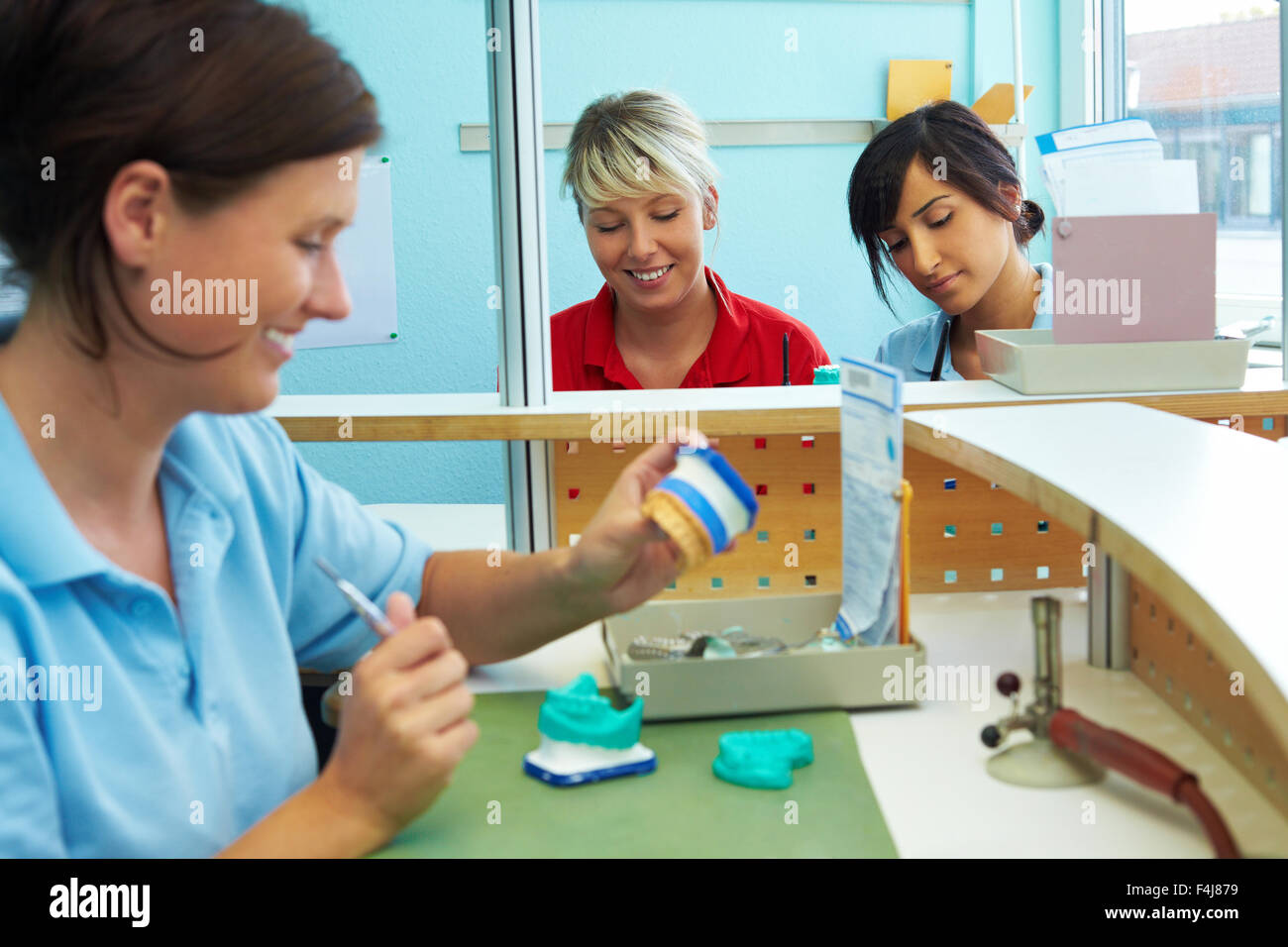 Three dental technicians working in a dental laboratory Stock Photo Alamy