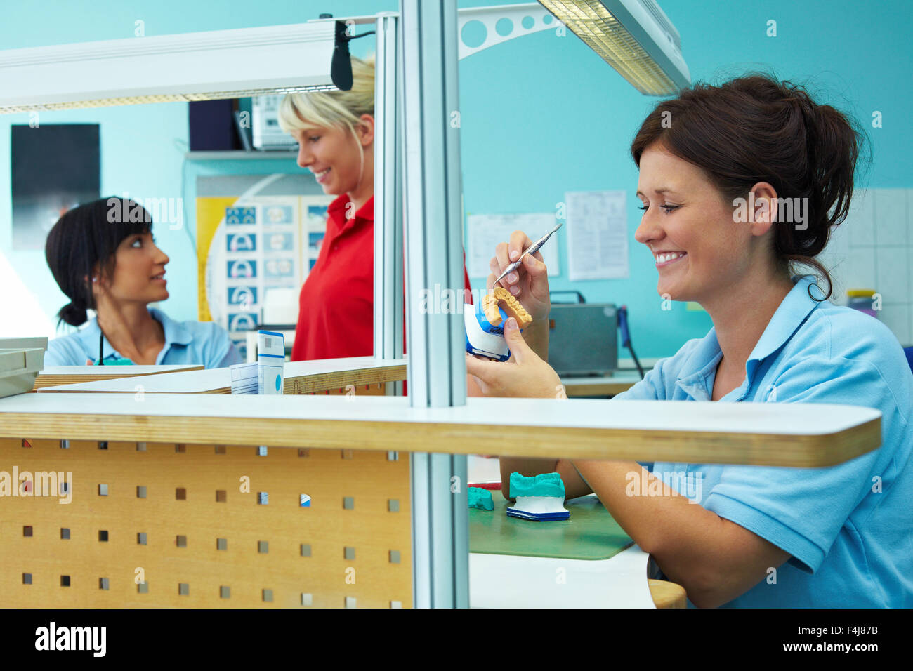 Three dental technicians working in a dental laboratory Stock Photo Alamy