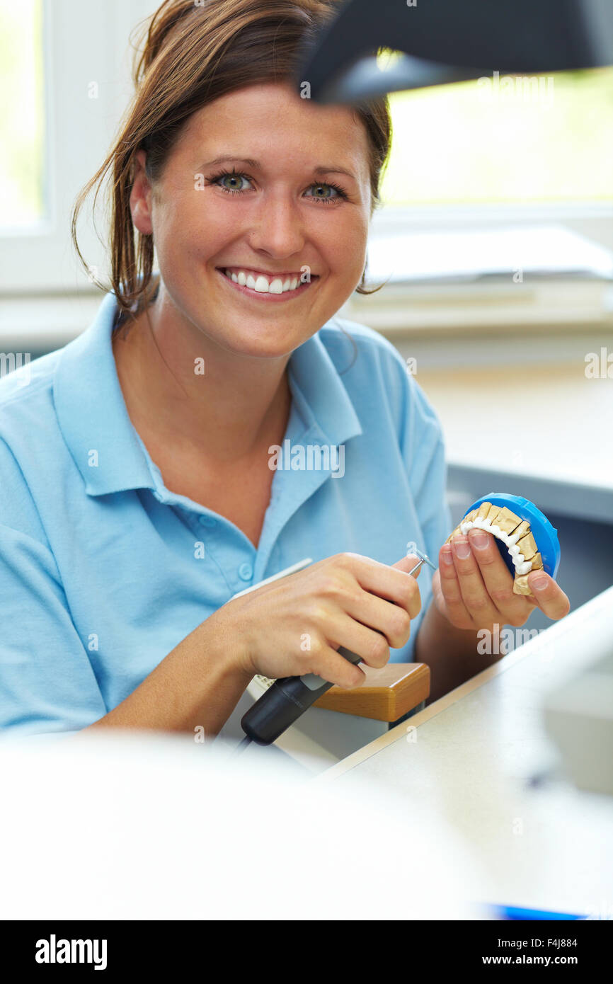 Dental technician milling a tooth for dentures Stock Photo Alamy