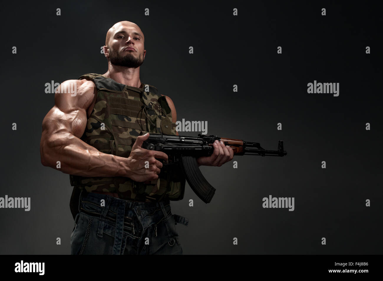 Studio portrait of soldier with a gun on black background Stock Photo ...