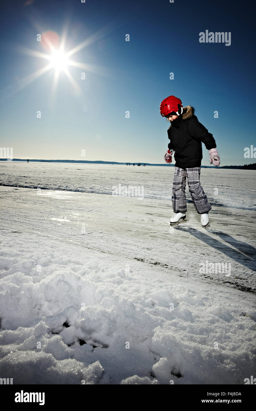 Girl skating under a beaming sun, Sweden. Stock Photo