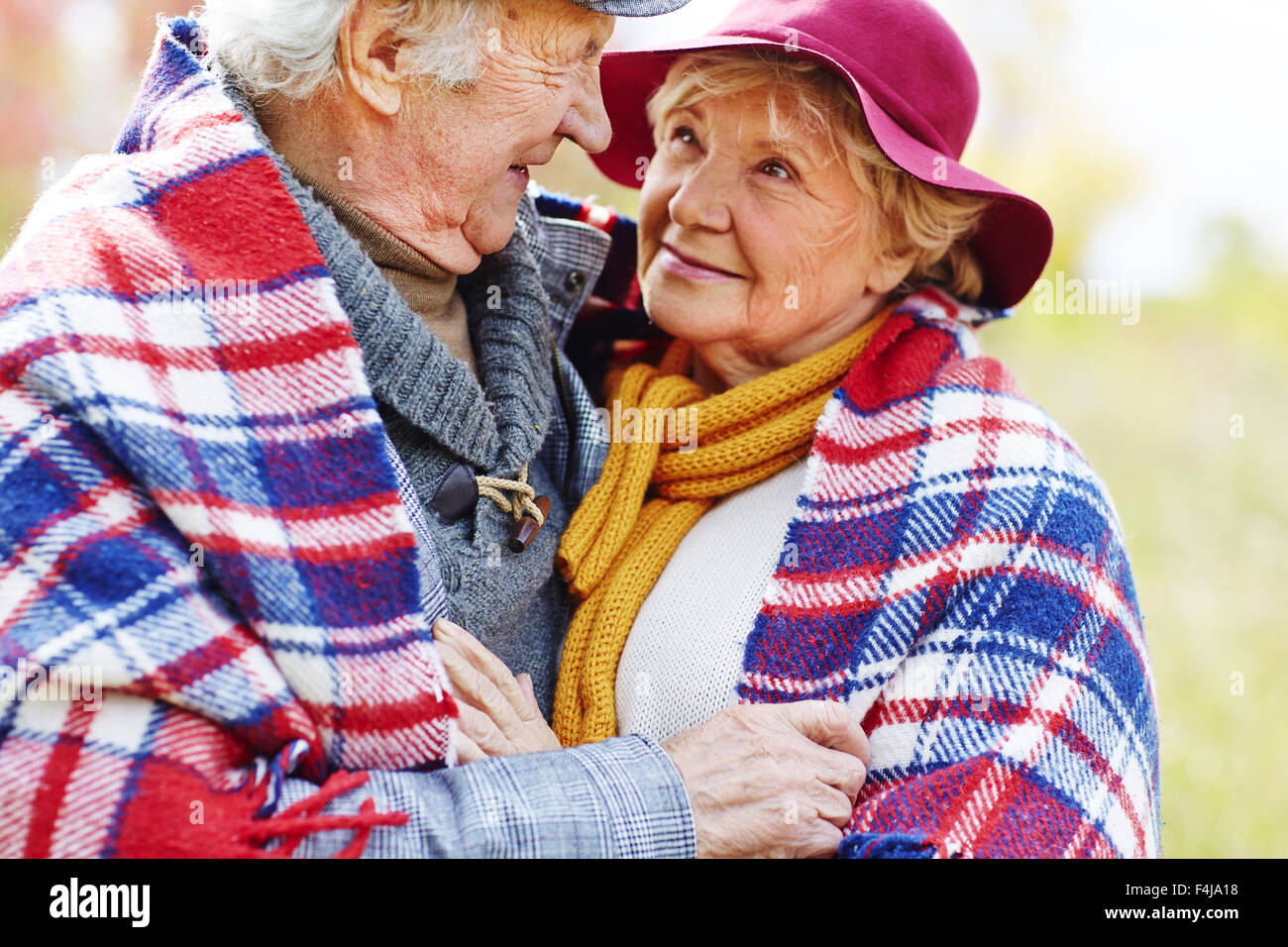 Retired couple in embrace looking at one another Stock Photo