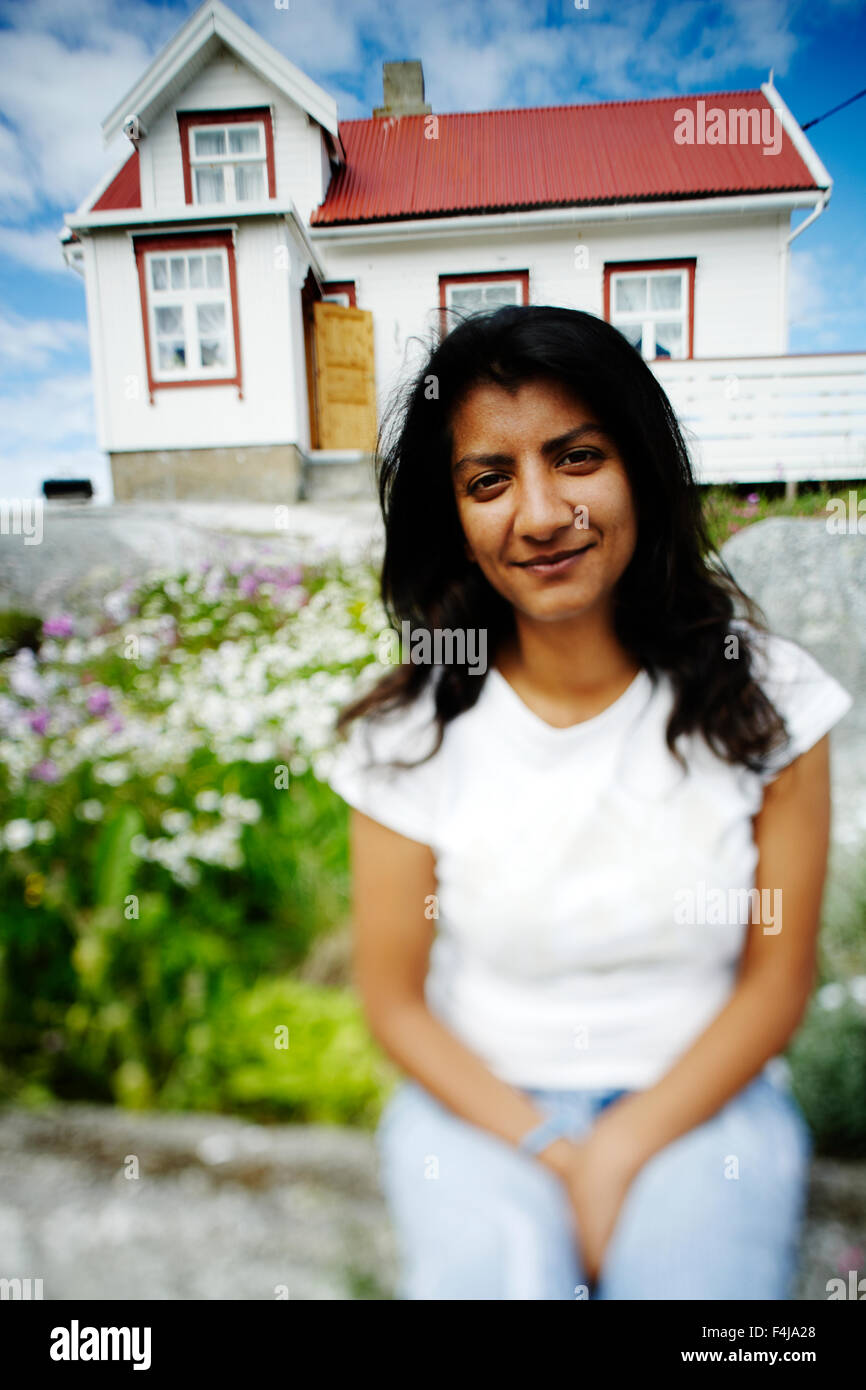 Portrait of a woman sitting in front of a house, Norway Stock Photo Alamy