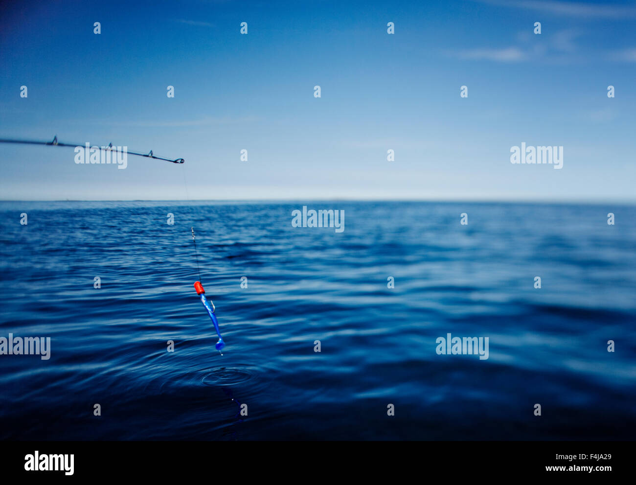 A fishing-rod and blue water. Stock Photo