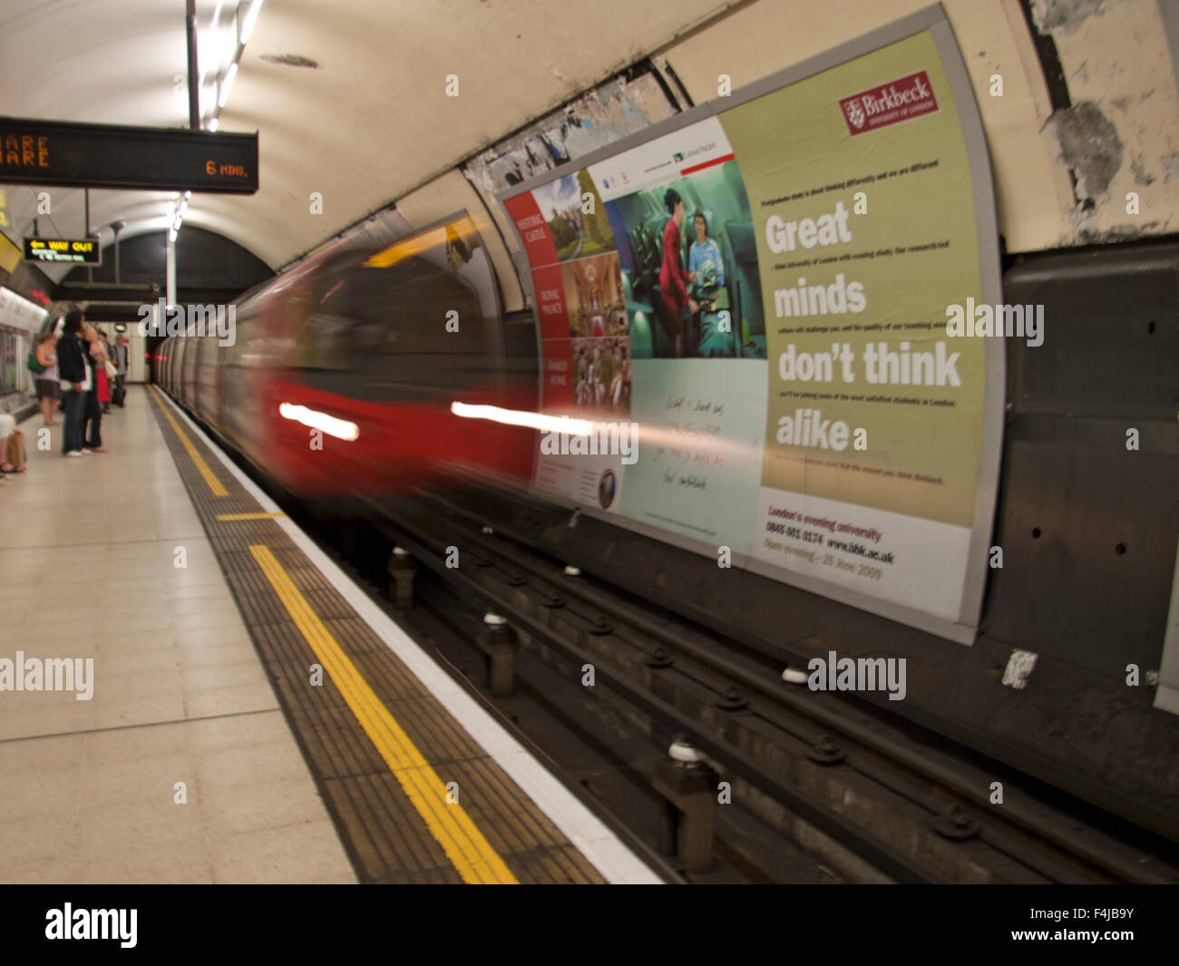 An underground train leaving the platform in London. Stock Photo