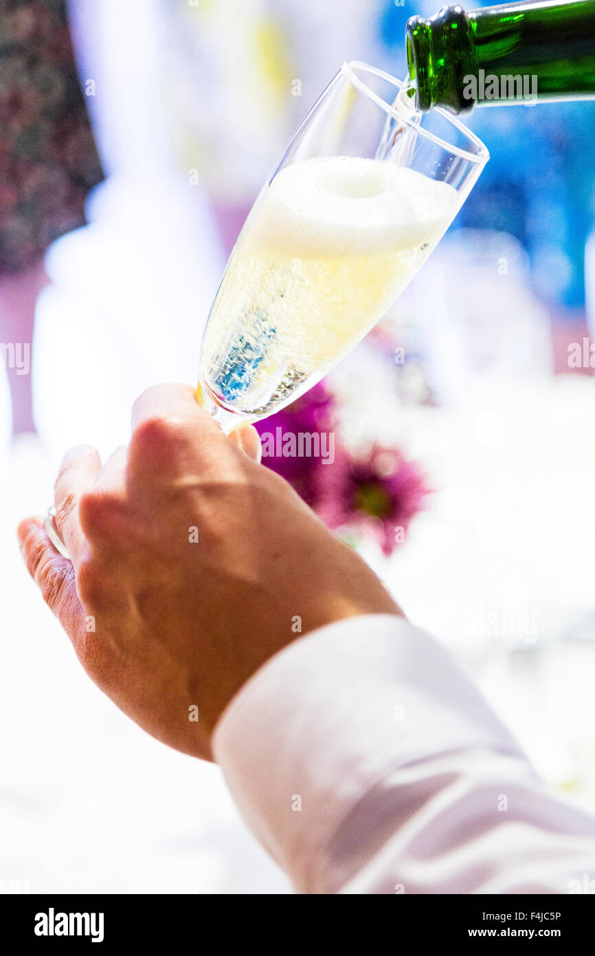 Sparkling wine being poured into a champagne flute. Stock Photo