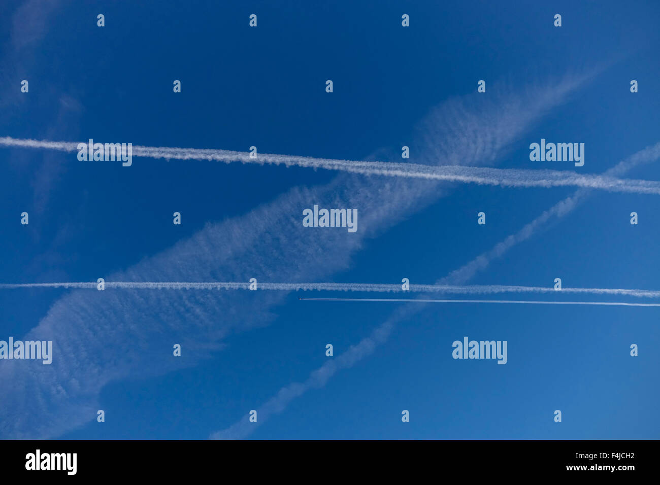 Multiple contrails with aircraft visible over the countryside in the Loire Valley, France. Stock Photo