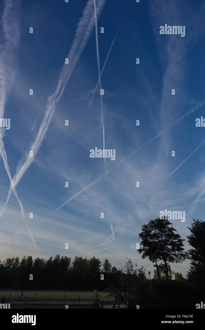 Multiple contrails with aircraft visible over the countryside in the Loire Valley, France. Stock Photo