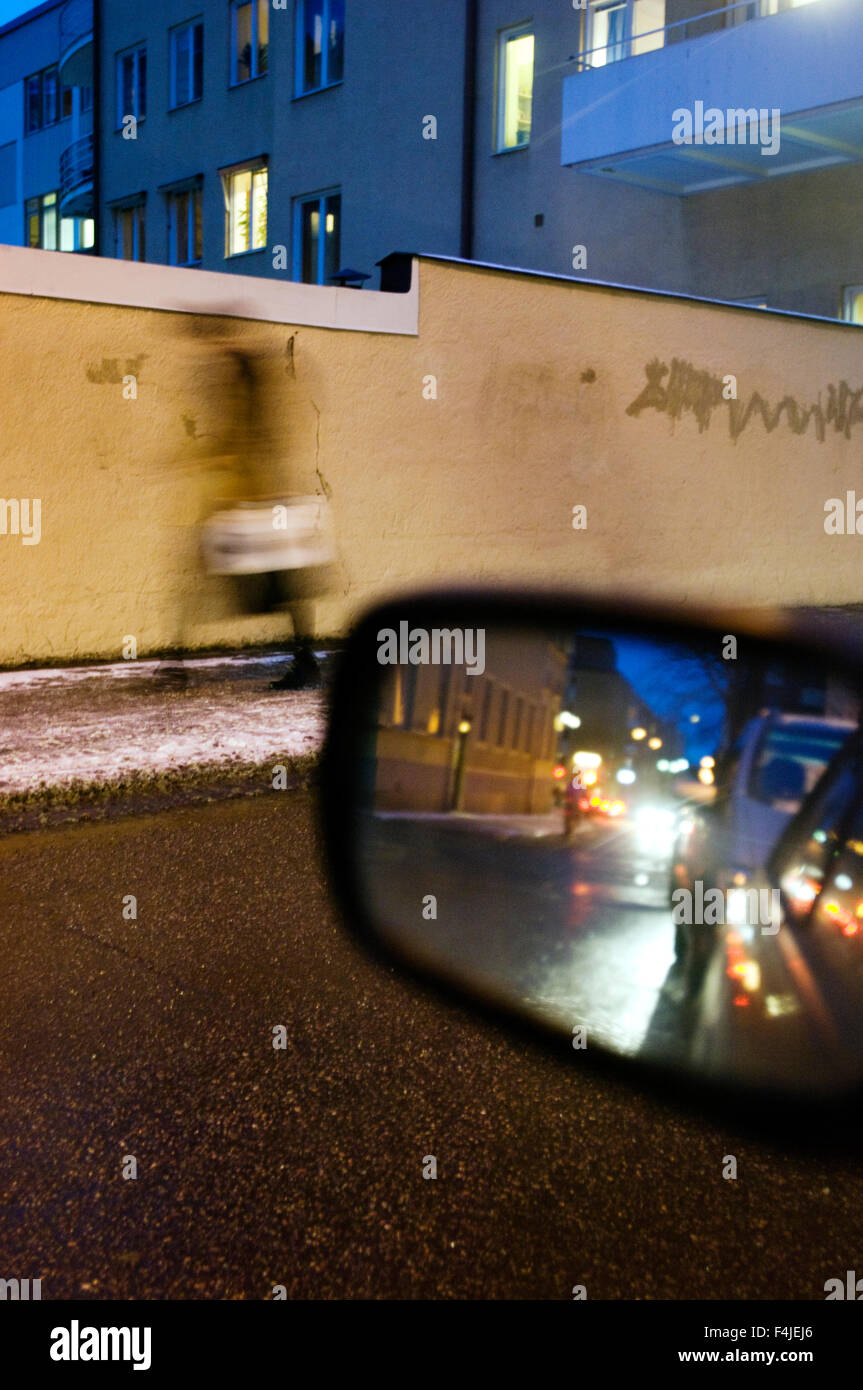 View of wing mirror with buildings in background Stock Photo