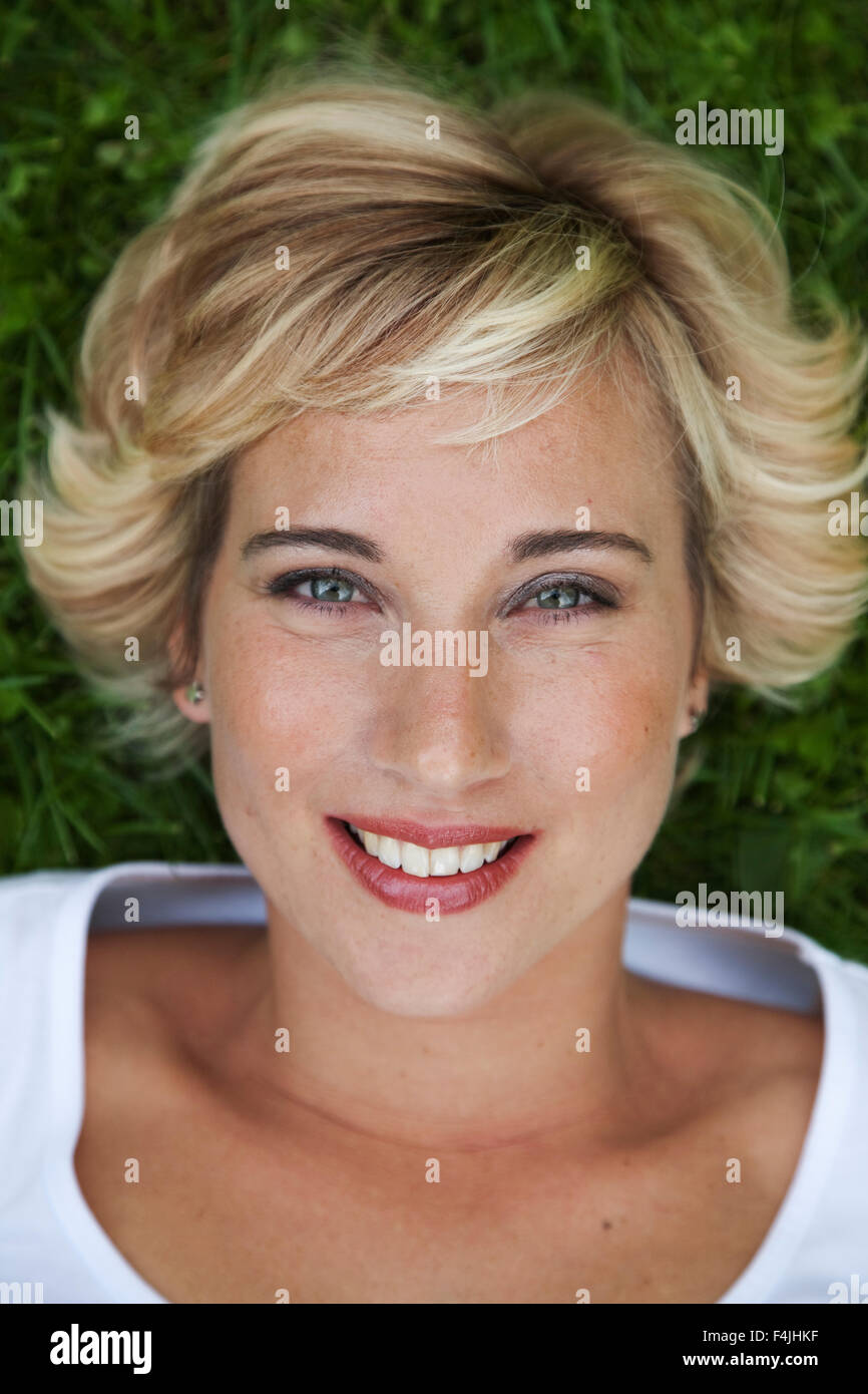Sweden, Stockholm, portrait of woman lying on grass Stock Photo - Alamy