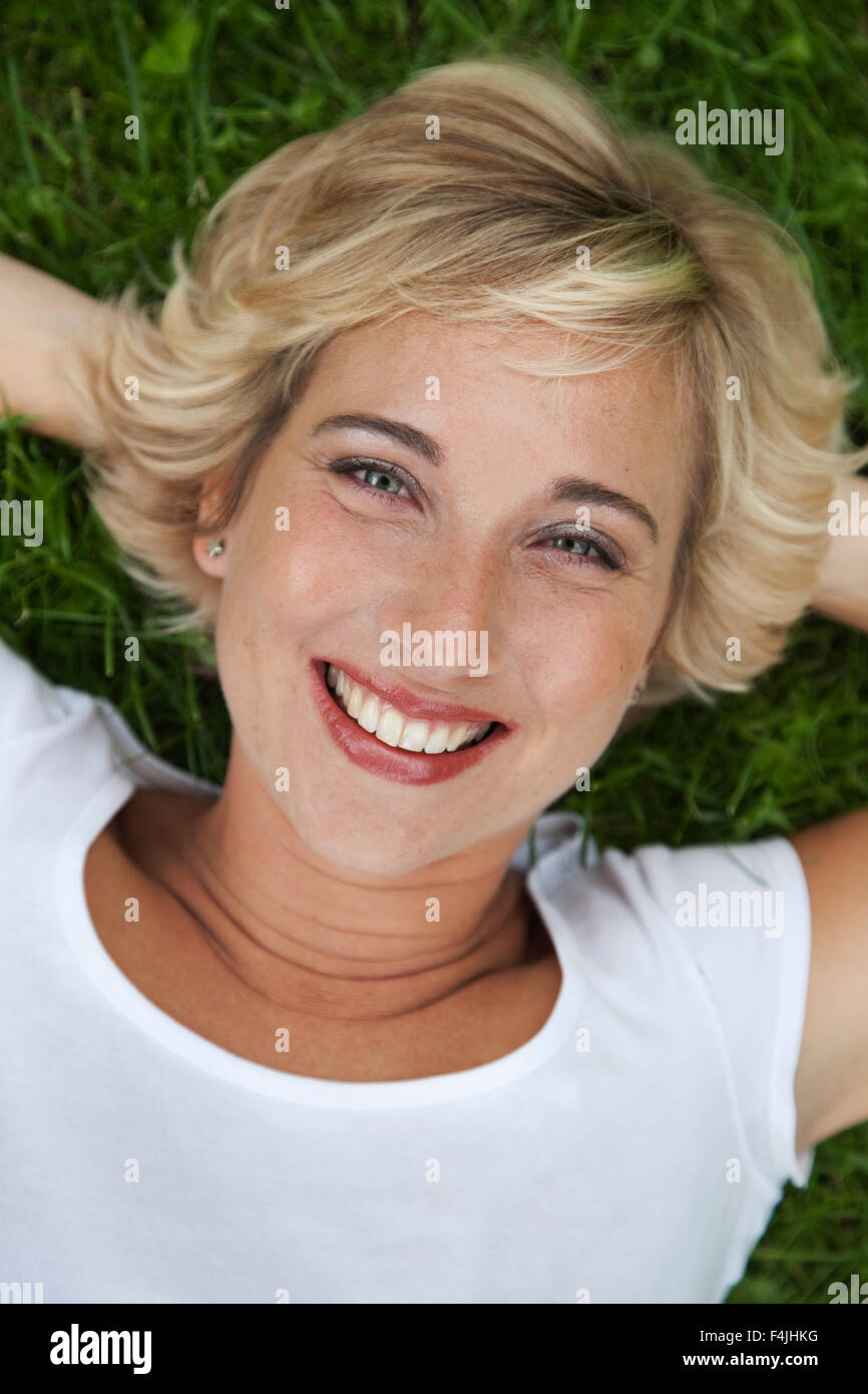 Sweden, Stockholm, portrait of woman lying on grass Stock Photo - Alamy