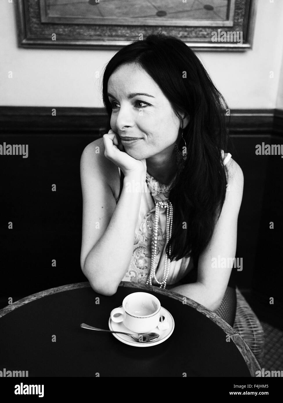 France, Paris, young woman in cafe Stock Photo