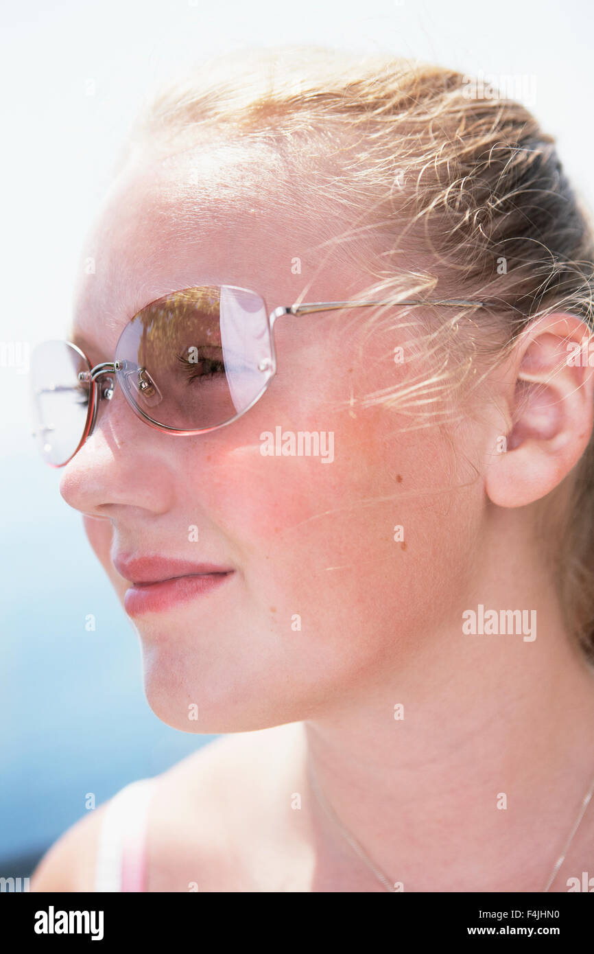 Italy, portrait of young woman wearing sunglasses Stock Photo