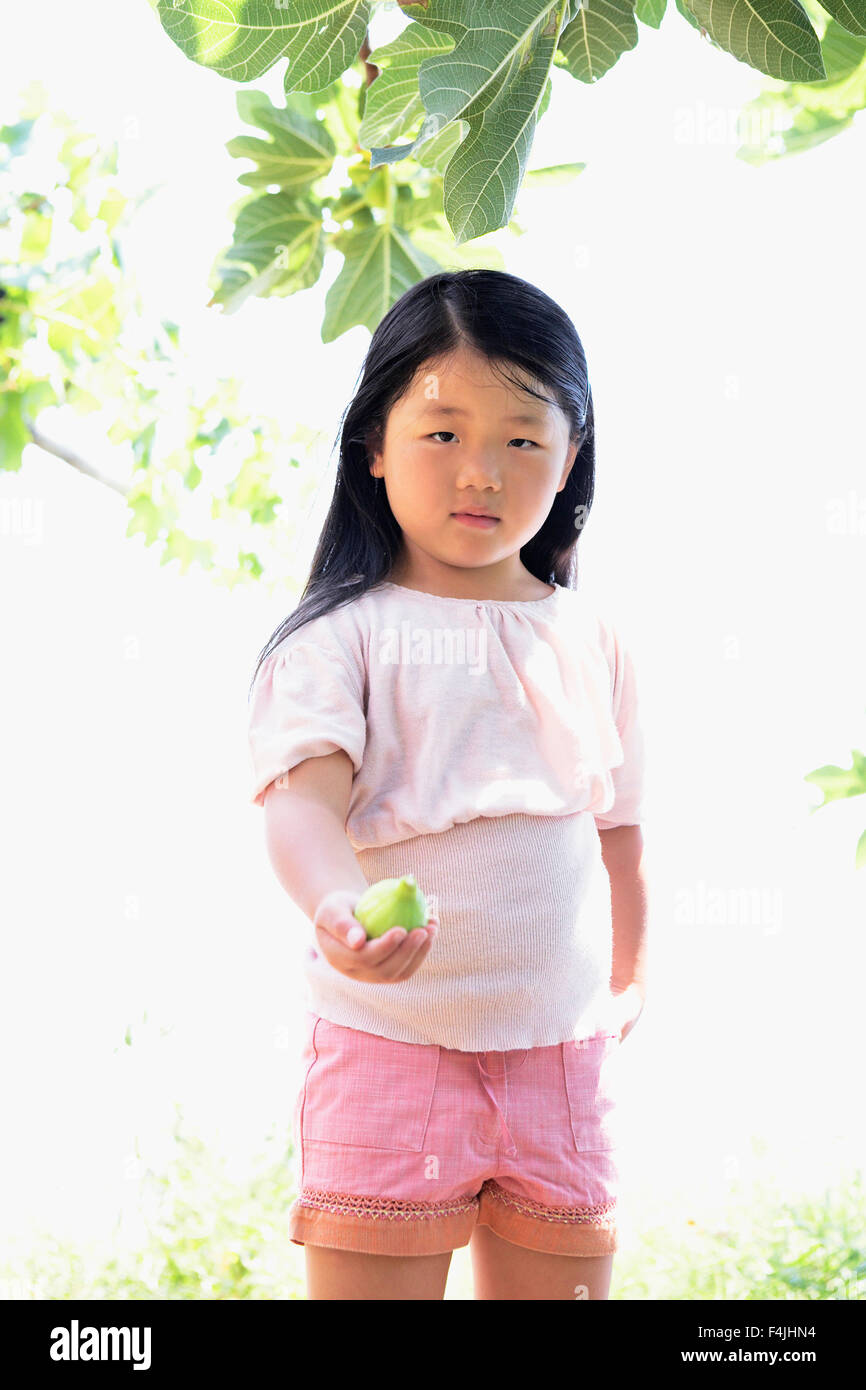 Italy, girl with fresh fig Stock Photo