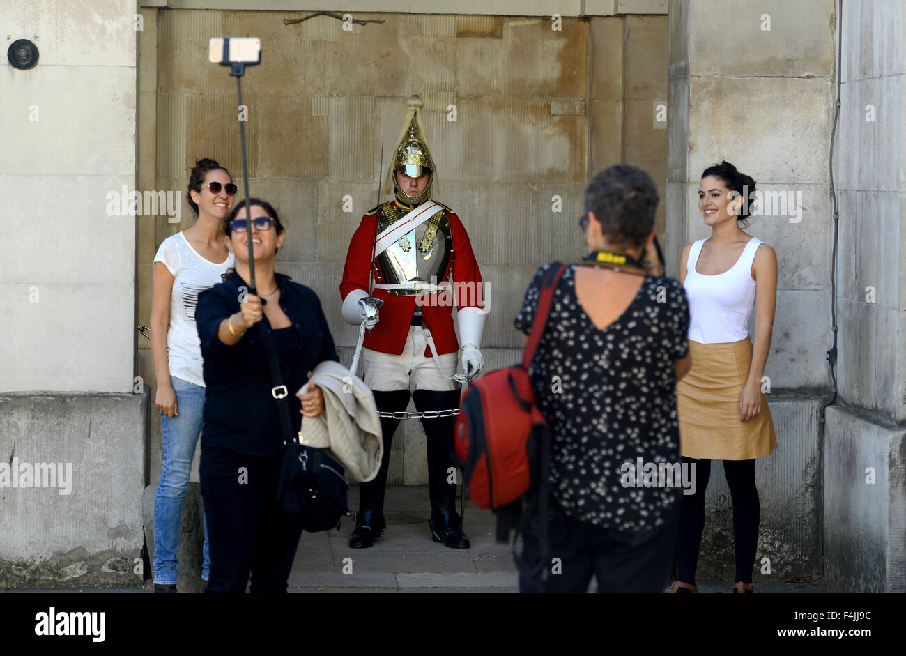 Tourists take a selfie in front of a soldier at "Horse Guards" London, UK Stock Photo