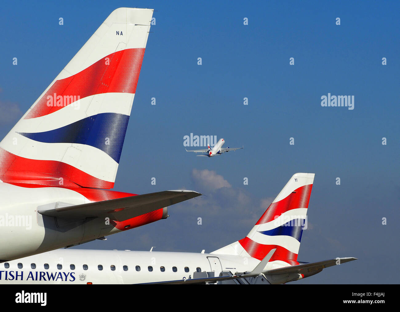 British Airways plane taking off and two BA tail fins, London City Airport, London, Britain, UK Stock Photo