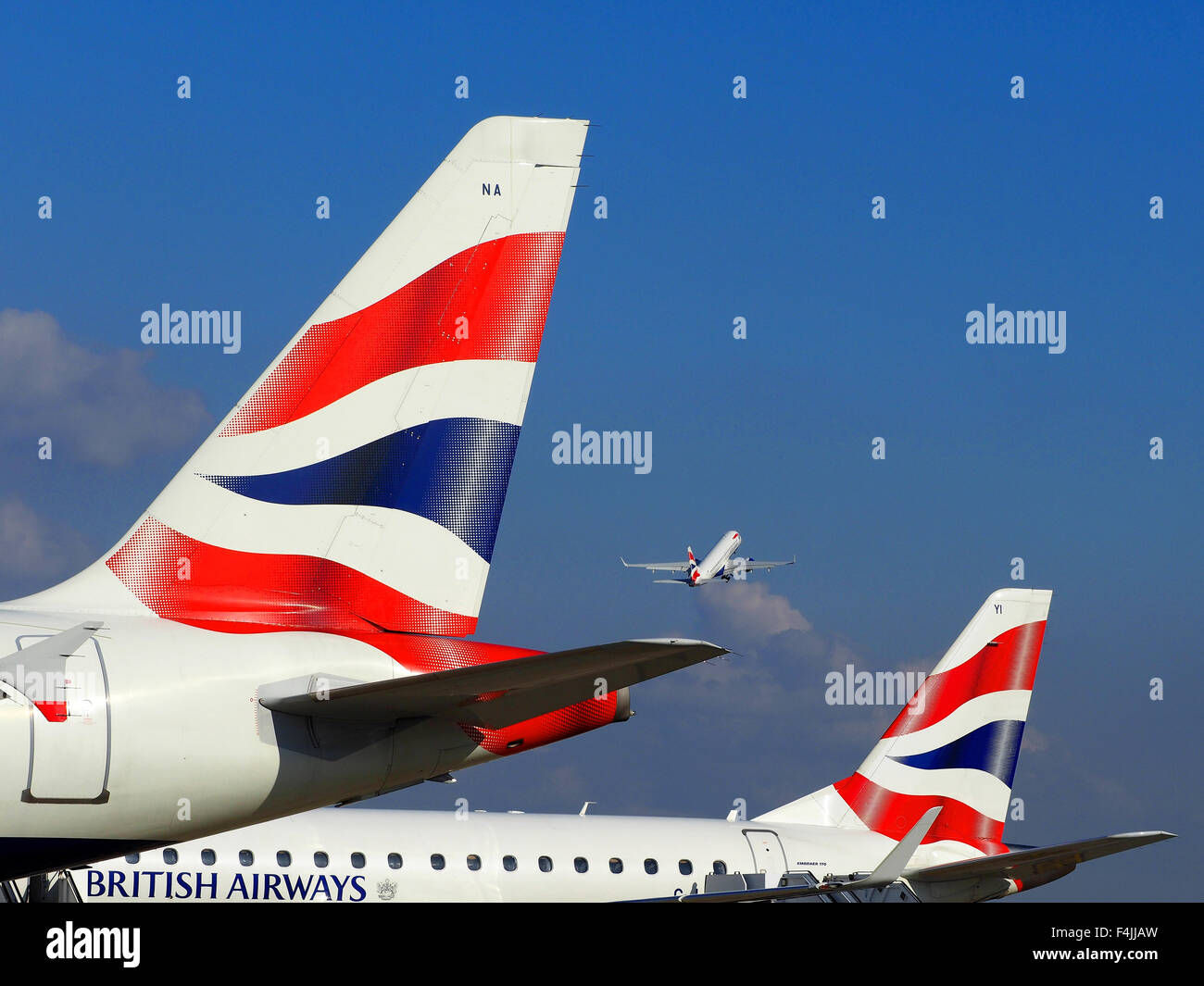 British Airways plane taking off and two BA tail fins, London City Airport, London, Britain, UK Stock Photo