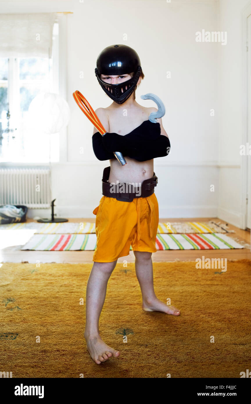 Portrait of boy wearing disguise in home Stock Photo