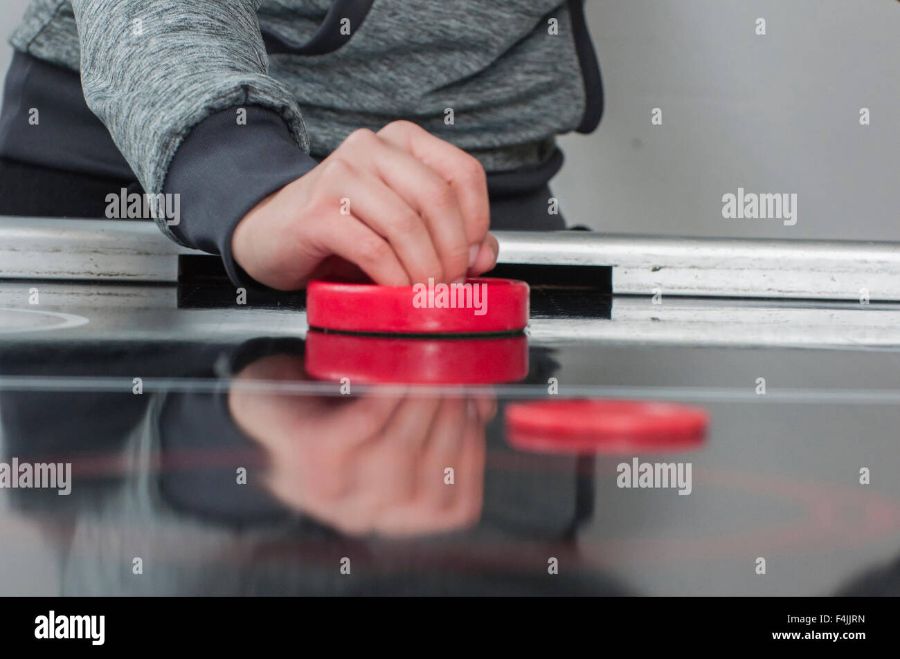 A young girl playing in a hockey games table. Stock Photo