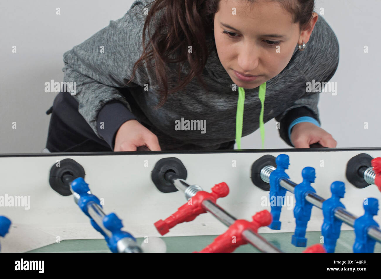 A young girl playing football table or footbal soccer Stock Photo - Alamy