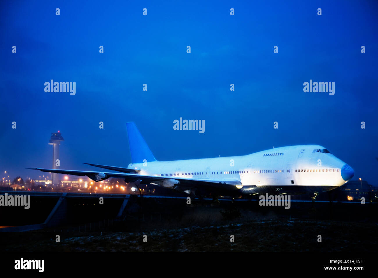 Airplane at airport at night Stock Photo - Alamy