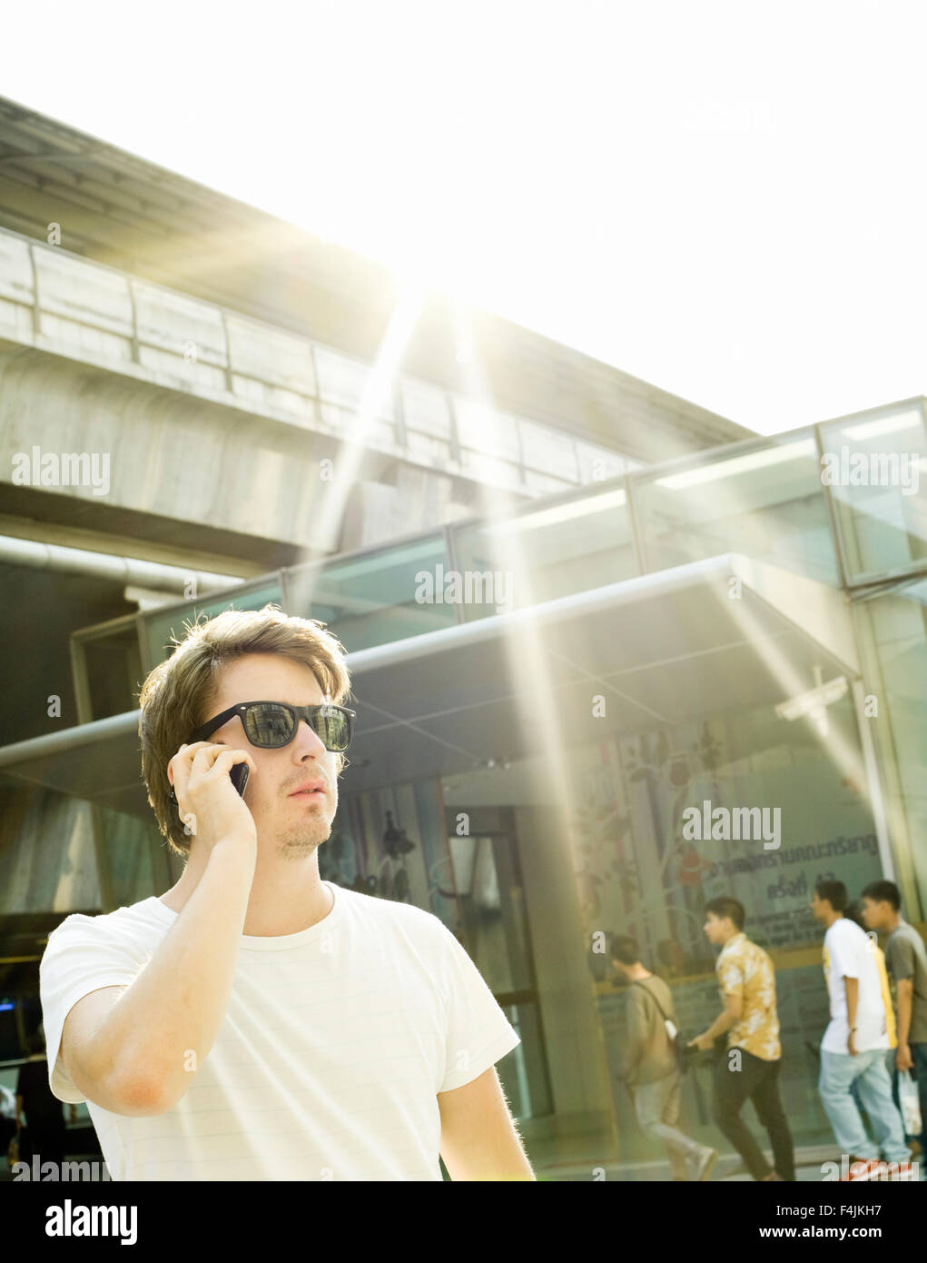 Man in sunglasses talking on mobile phone Stock Photo Alamy