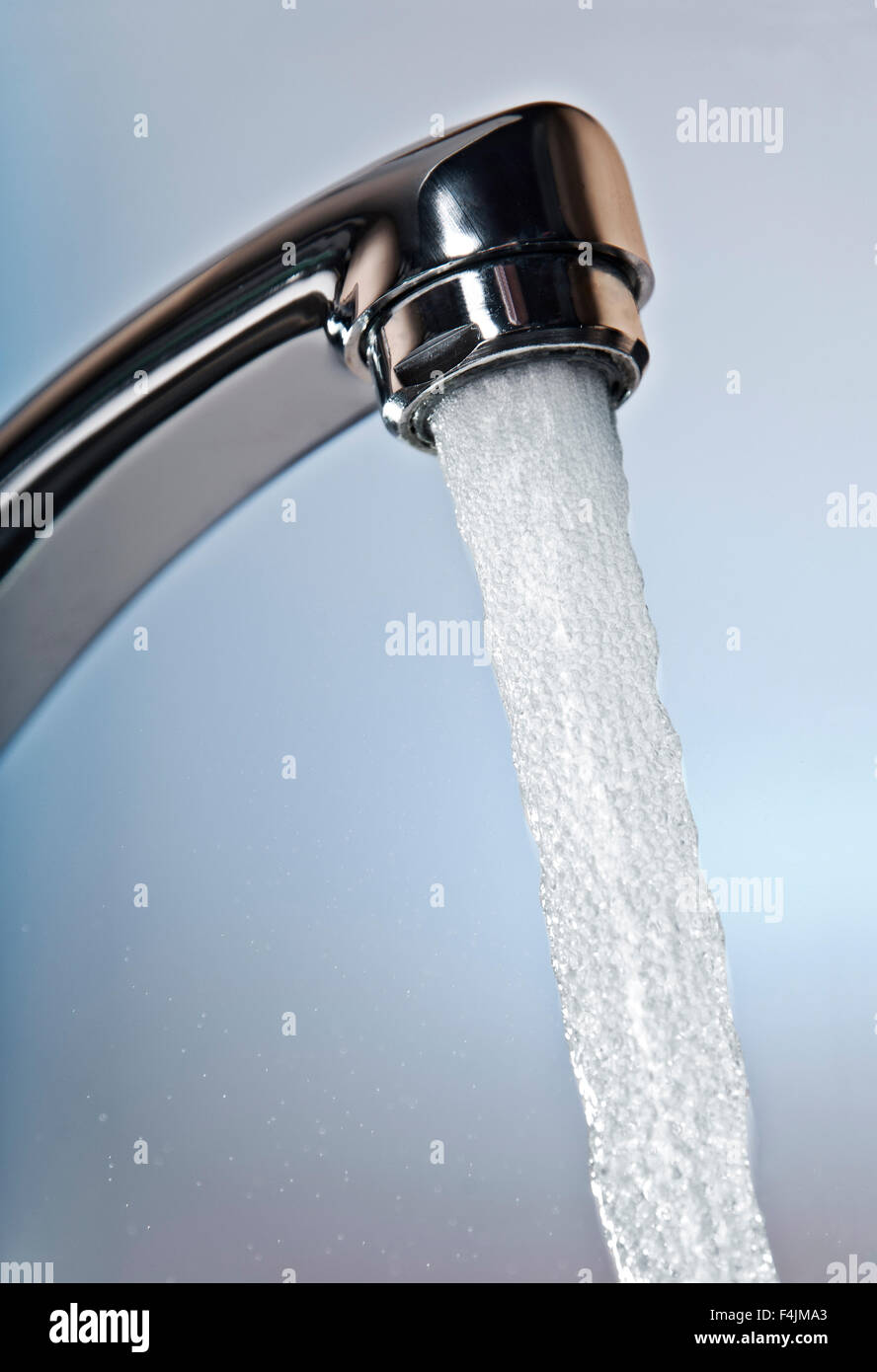 Water flows from a tap Stock Photo