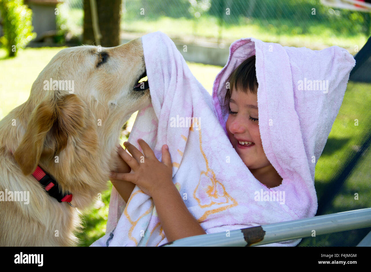 Little Girl Cuddling With Her Dog Stock Photos & Little Girl Cuddling