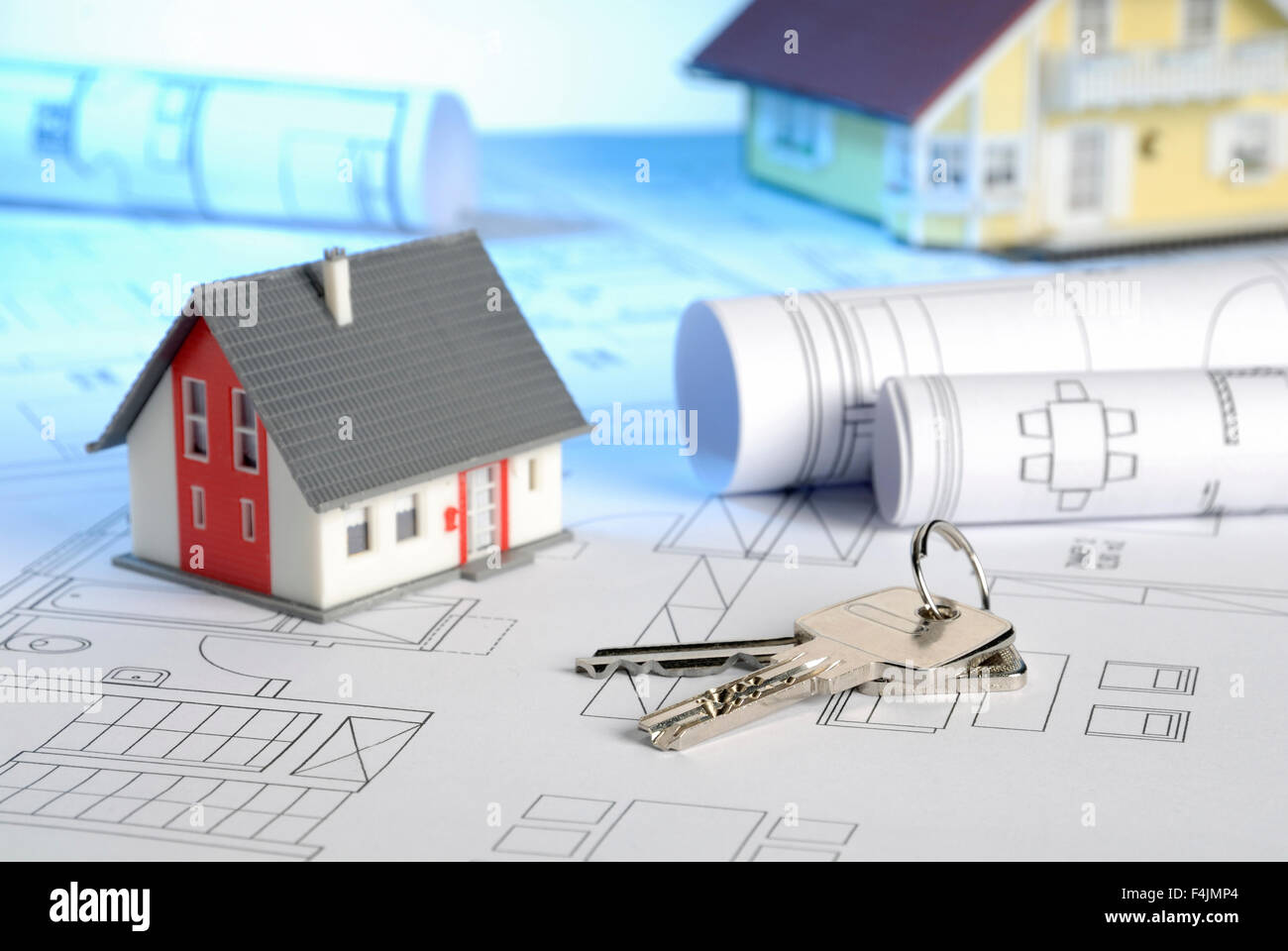 Blueprints with house keys and houses Stock Photo